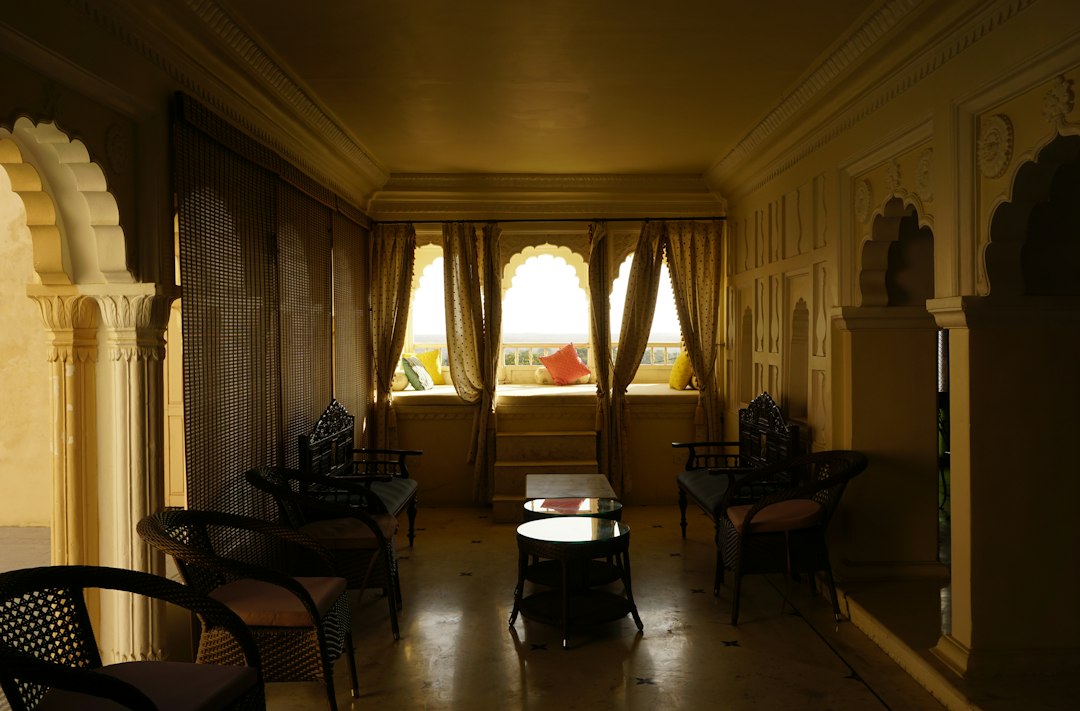 a dimly lit room with chairs and tables