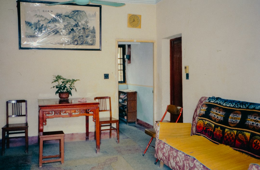A living room filled with furniture and a painting on the wall